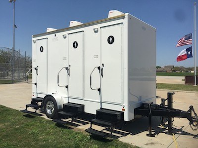 Mobile restroom trailer rented by Luxury Event Trailers, a division of Texas Outhouse, for outdoor events in Texas