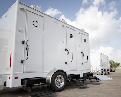 A bathroom trailer available for rent near me in Houston, Texas through Texas Outhouse