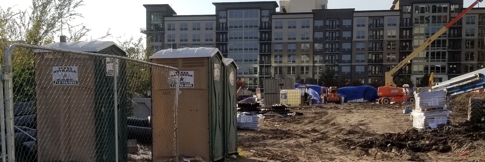 Portable toilets are stationed at a construction site in Houston