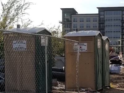 Portable toilets at a construction site that were rented from Texas Outhouse.