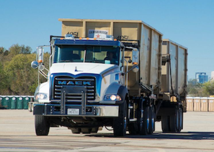 Dumpsters being hauled