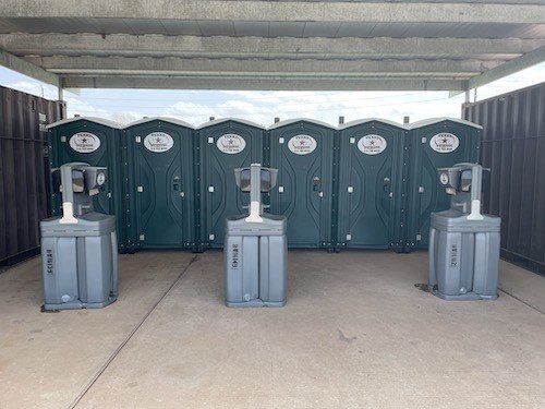 Texas Outhouse portable handwash stations next to portable restrooms