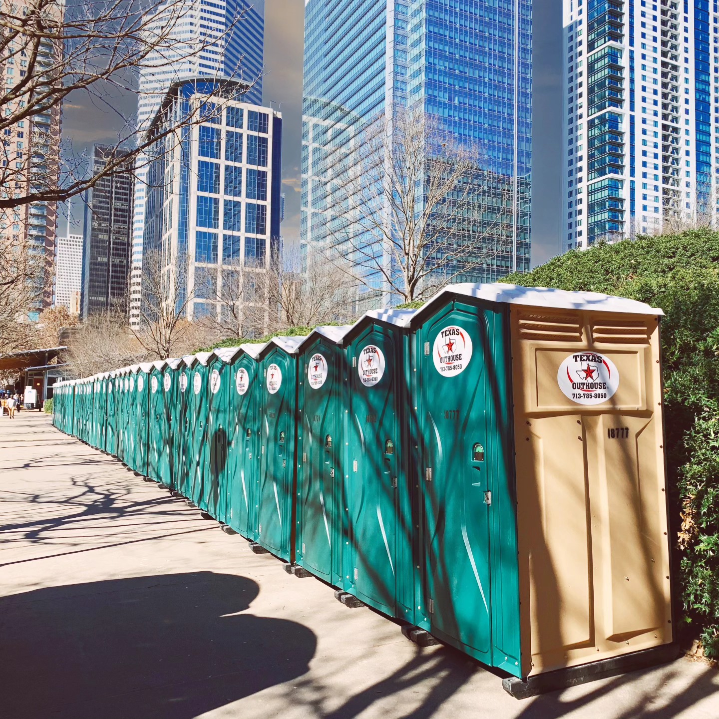 Standard portable toilets from Texas Outhouse lined up outside