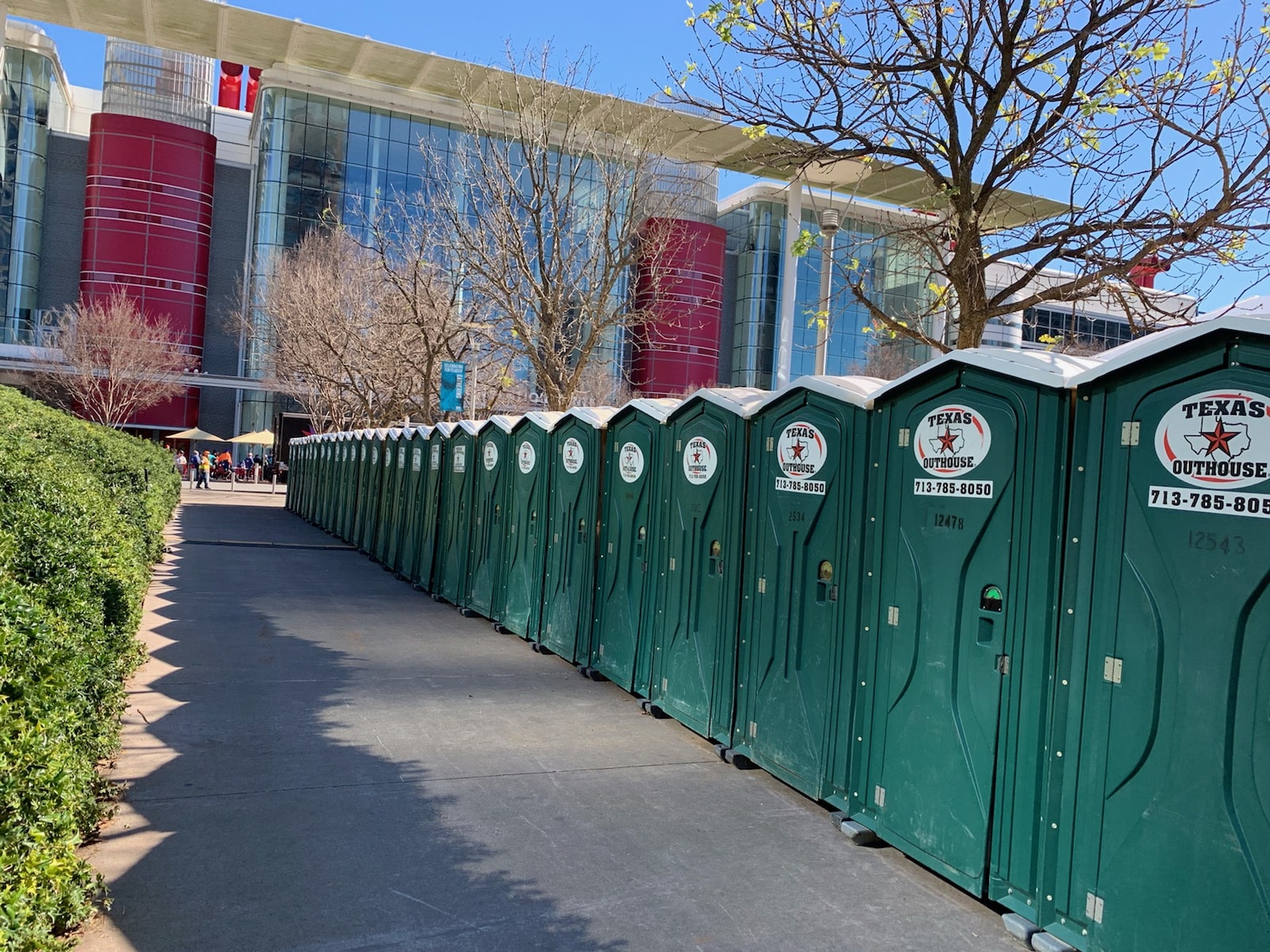 Portable toilets from Texas Outhouse lined up outside of a convention center in Houston