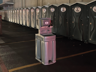 Texas Outhouse handwashing station along with portable toilets placed near a job site