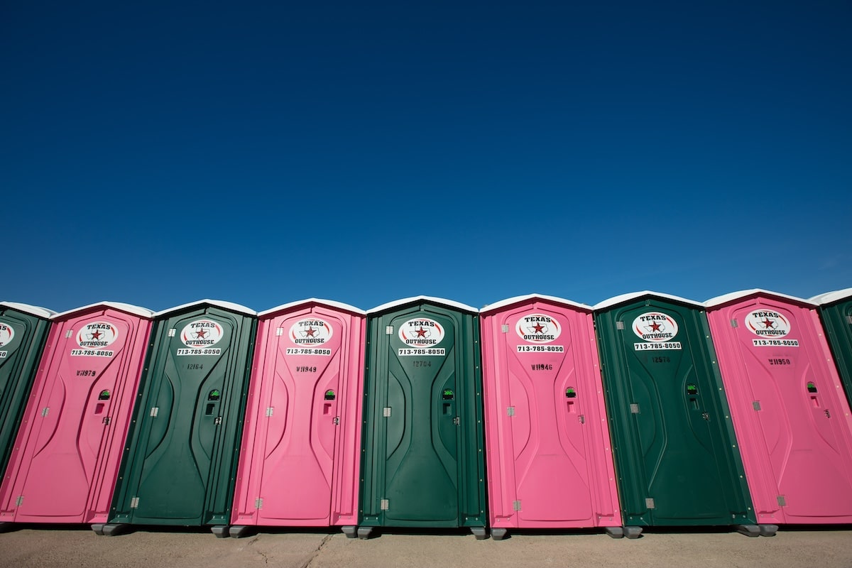 Row of Texas Outhouse portable toilets lined up ready to be mobilized to the job site in Houston