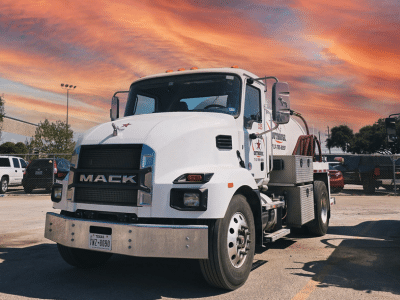 Texas Outhouse truck positioned outside of a job site
