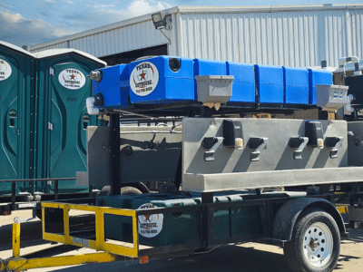 Texas Outhouse portable toilets and handwashing stations positioned outside of a construction site